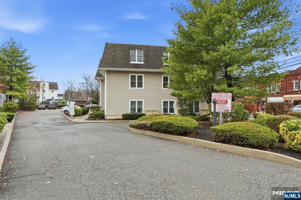 253 Park Avenue, Unit 305 Rutherford, NJ 07070 - Photo 6 of 7 a front view of a house with a yard and garage
