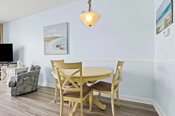 a view of a dining room with furniture and wooden floor