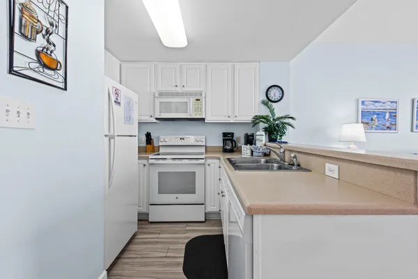 a kitchen with a sink a stove and cabinets