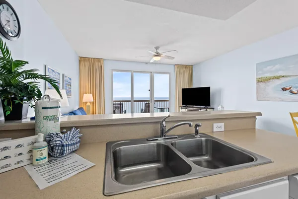a kitchen with a sink and a stove top oven