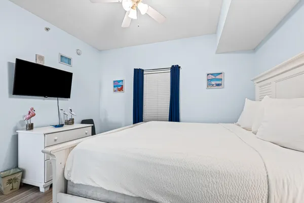 a bedroom with a bed and a flat screen tv