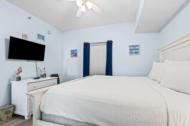 a bedroom with a bed and a flat screen tv