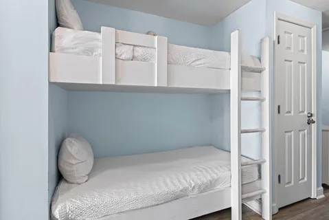 a bedroom with a bed and chair