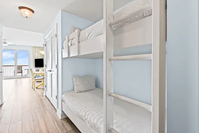 a bedroom with a bed and a view of living room