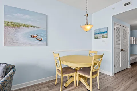 a view of a dining room with a table and chairs