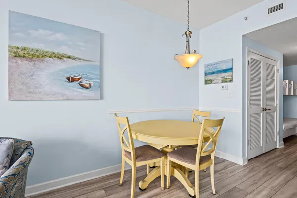 a view of a dining room with a table and chairs