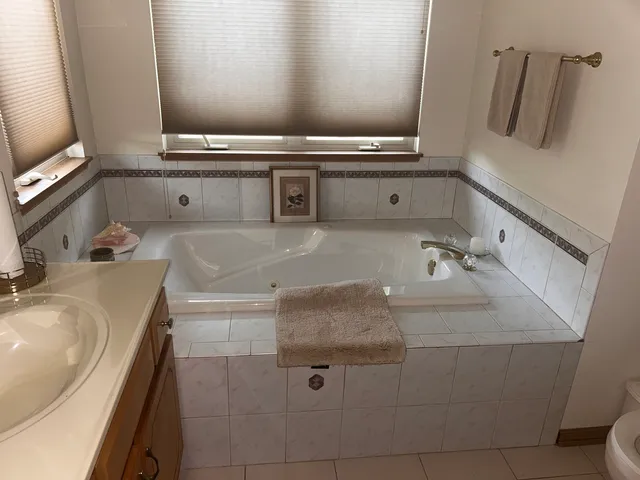 a bathroom with a granite countertop sink a mirror and vanity