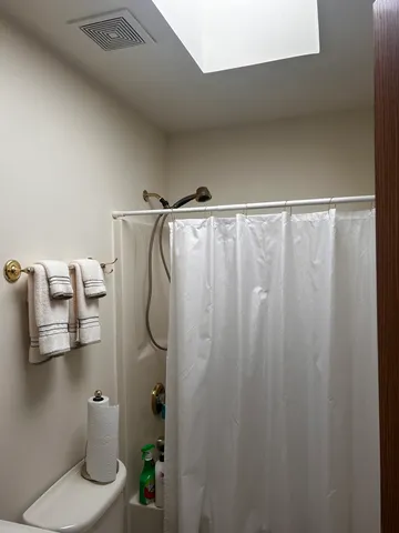 a bathroom with a shower and a toilet
