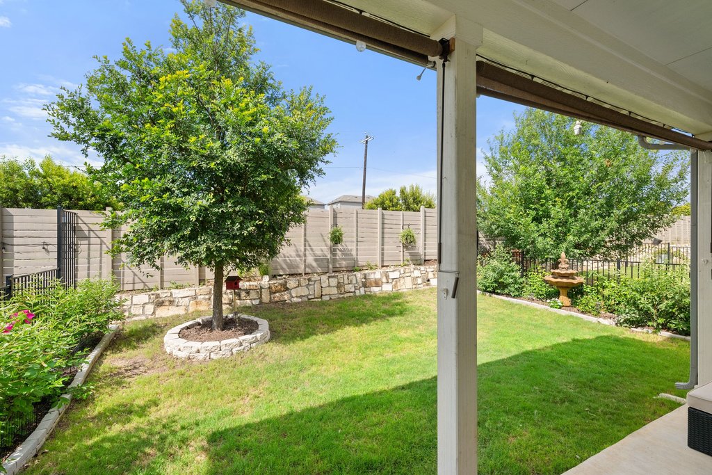 7403 Travertine Spring Drive, Unit 117 Austin, TX 78744 - Photo 29 of 37 A well-maintained lawn and verdant landscaping create a serene outdoor retreat.