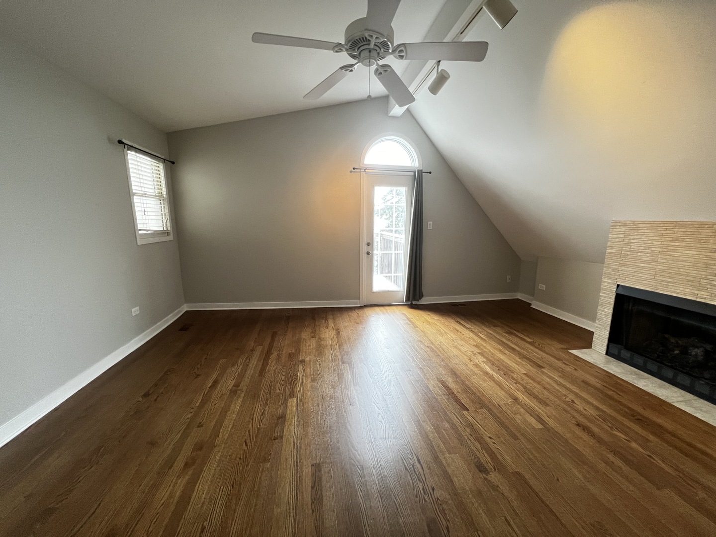 Undisclosed Address Chicago, IL 60657 - Photo 11 of 25 an empty room with wooden floor fireplace and windows