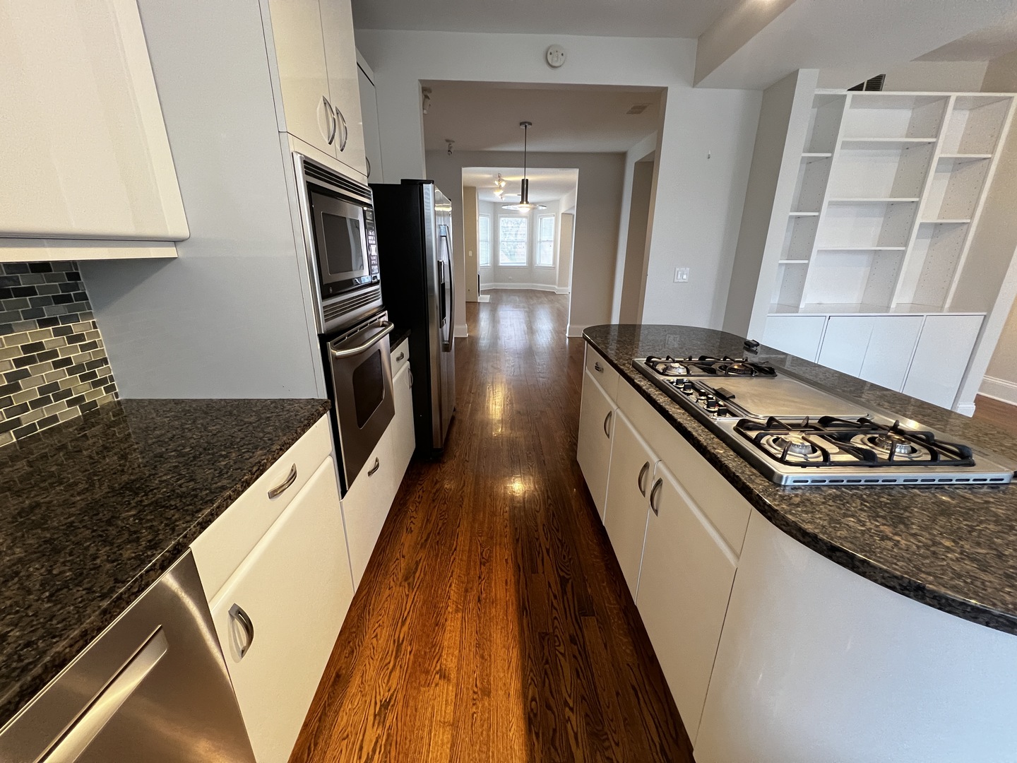 Undisclosed Address Chicago, IL 60657 - Photo 5 of 25 a kitchen with granite countertop a stove and a refrigerator