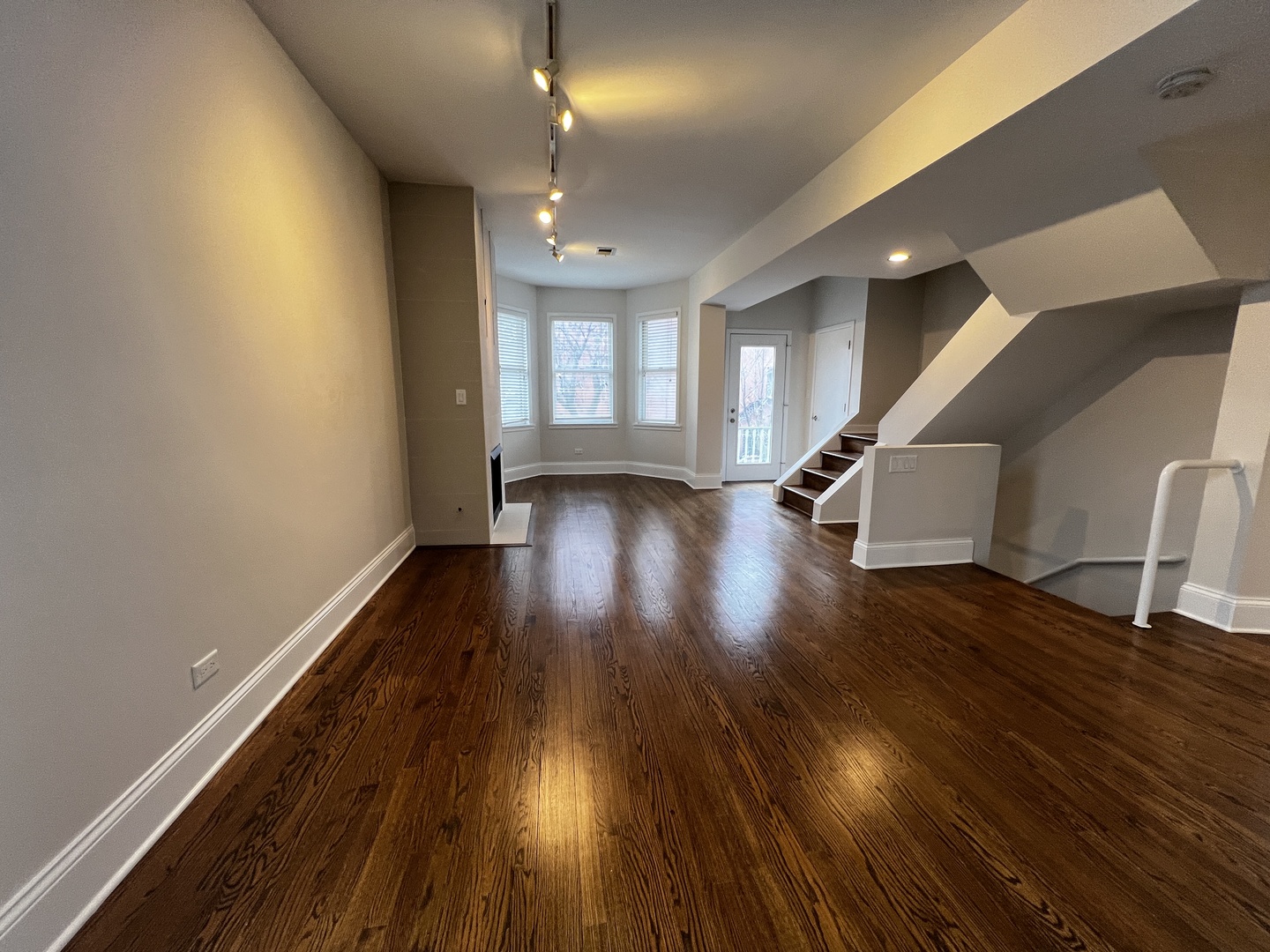 Undisclosed Address Chicago, IL 60657 - Photo 7 of 25 a view of an empty room with wooden floor and a window