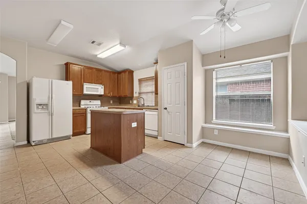 a kitchen with stainless steel appliances a refrigerator and a stove top oven