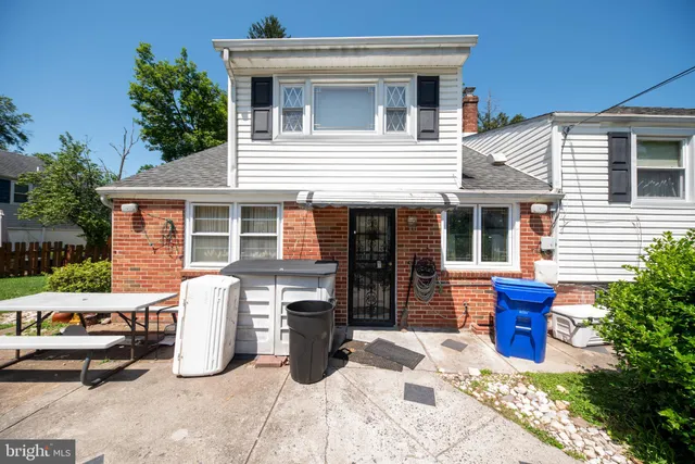 a front view of a house with outdoor seating
