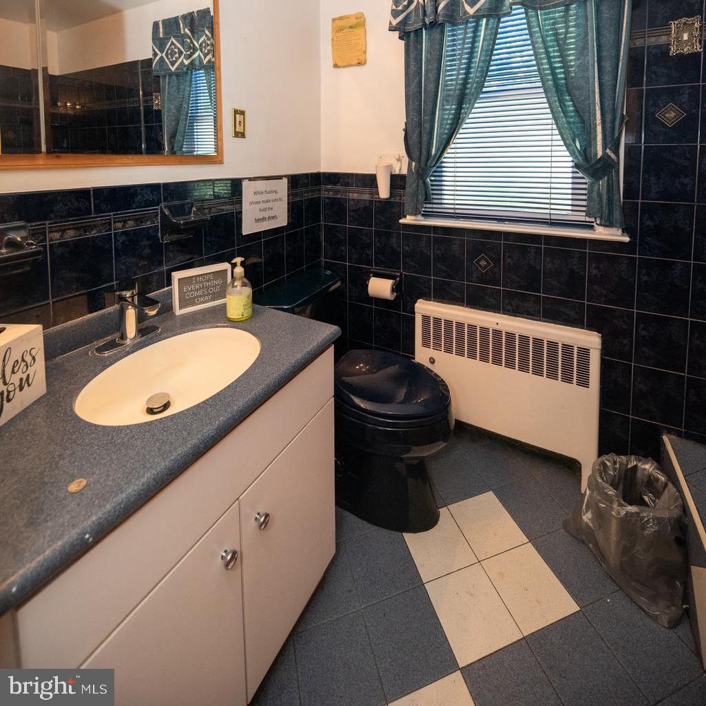 1612 East Willow Grove Avenue Glenside, PA 19038 - Photo 15 of 15 a bathroom with a sink a mirror and a toilet