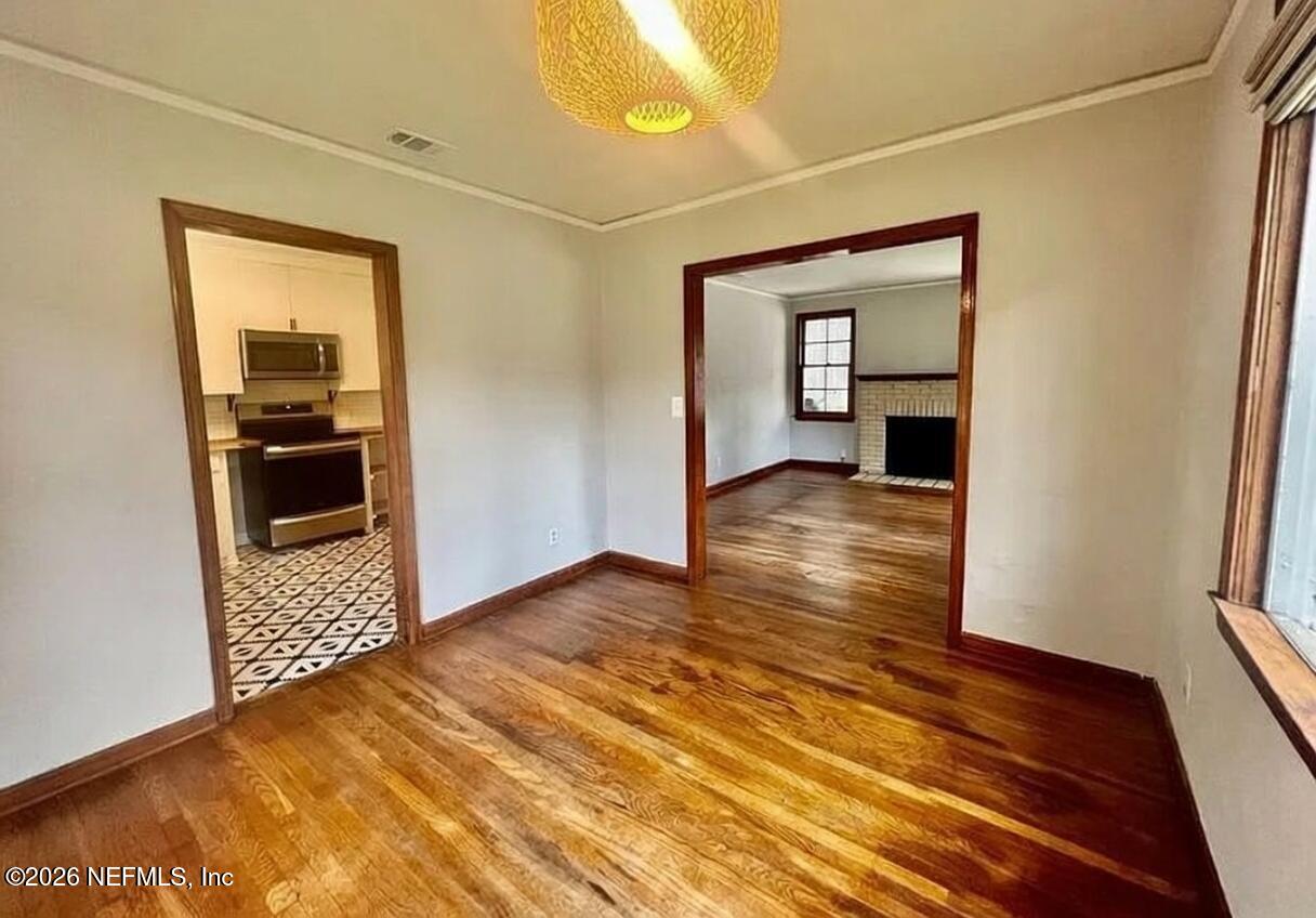 4659 Post Street Jacksonville, FL 32205 - Photo 11 of 24 a view of a hallway with wooden floor and a bathroom