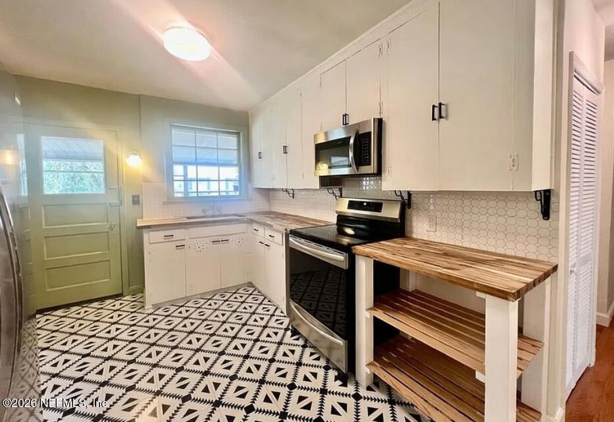 4659 Post Street Jacksonville, FL 32205 - Photo 13 of 24 a kitchen with a sink stove and microwave