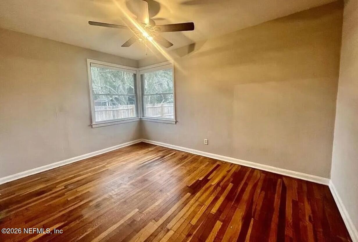 4659 Post Street Jacksonville, FL 32205 - Photo 16 of 24 a view of an empty room with wooden floor and a window