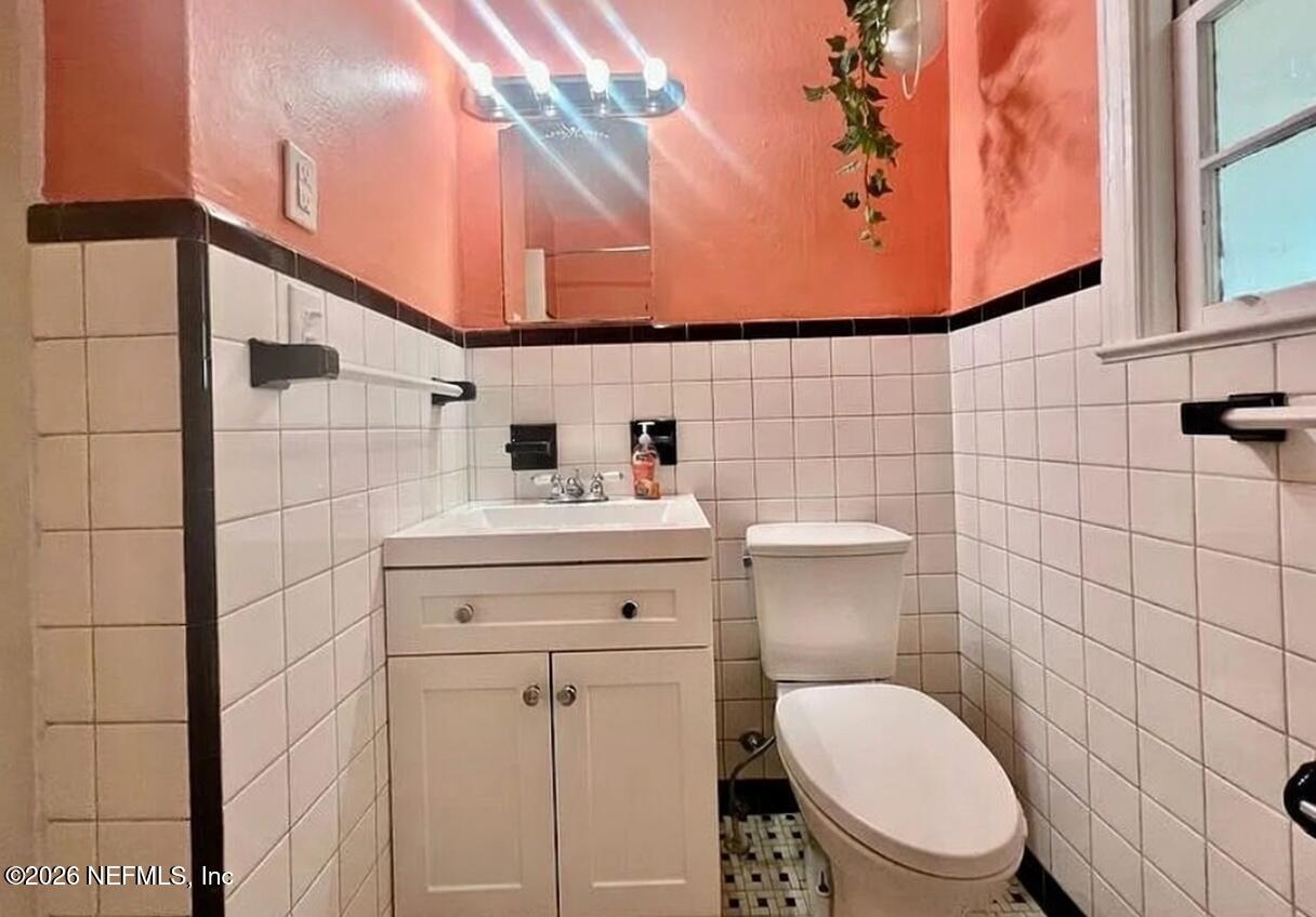 4659 Post Street Jacksonville, FL 32205 - Photo 19 of 24 a bathroom with a toilet sink and mirror