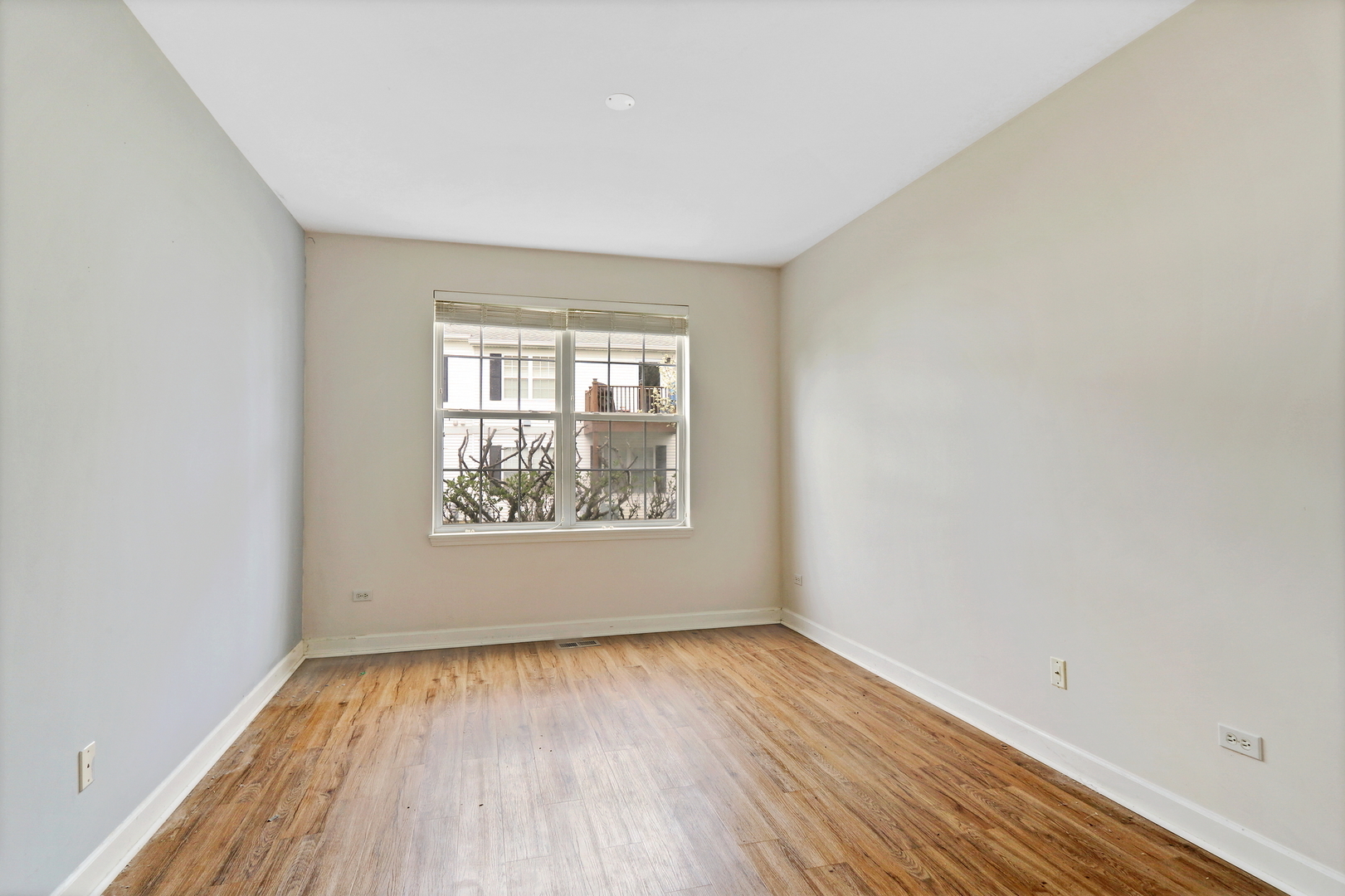 3175 Falling Waters Lane Lindenhurst, IL 60046 - Photo 12 of 19 an empty room with wooden floor and windows