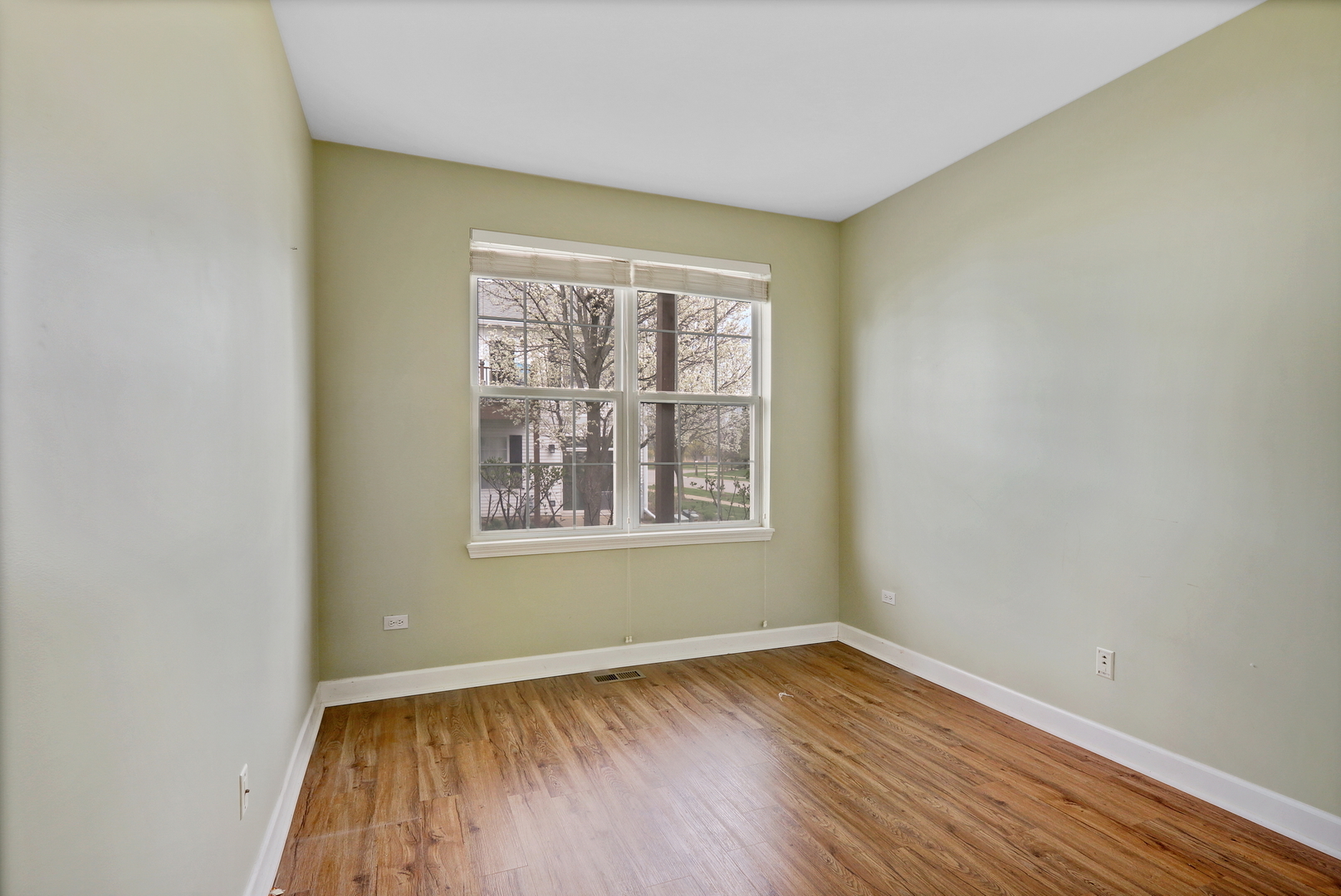 3175 Falling Waters Lane Lindenhurst, IL 60046 - Photo 16 of 19 an empty room with wooden floor and windows
