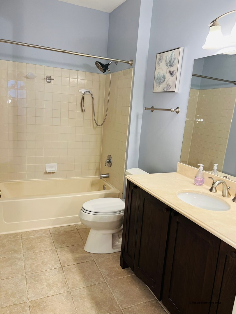 3175 Falling Waters Lane Lindenhurst, IL 60046 - Photo 17 of 19 a bathroom with a sink a toilet and a shower