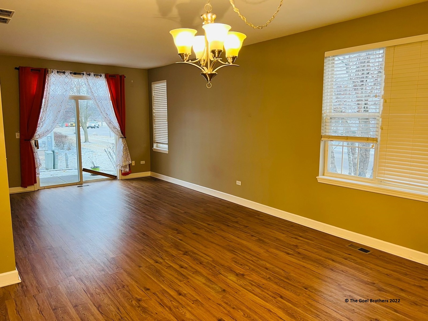 3175 Falling Waters Lane Lindenhurst, IL 60046 - Photo 3 of 19 a view of an empty room with wooden floor and a window