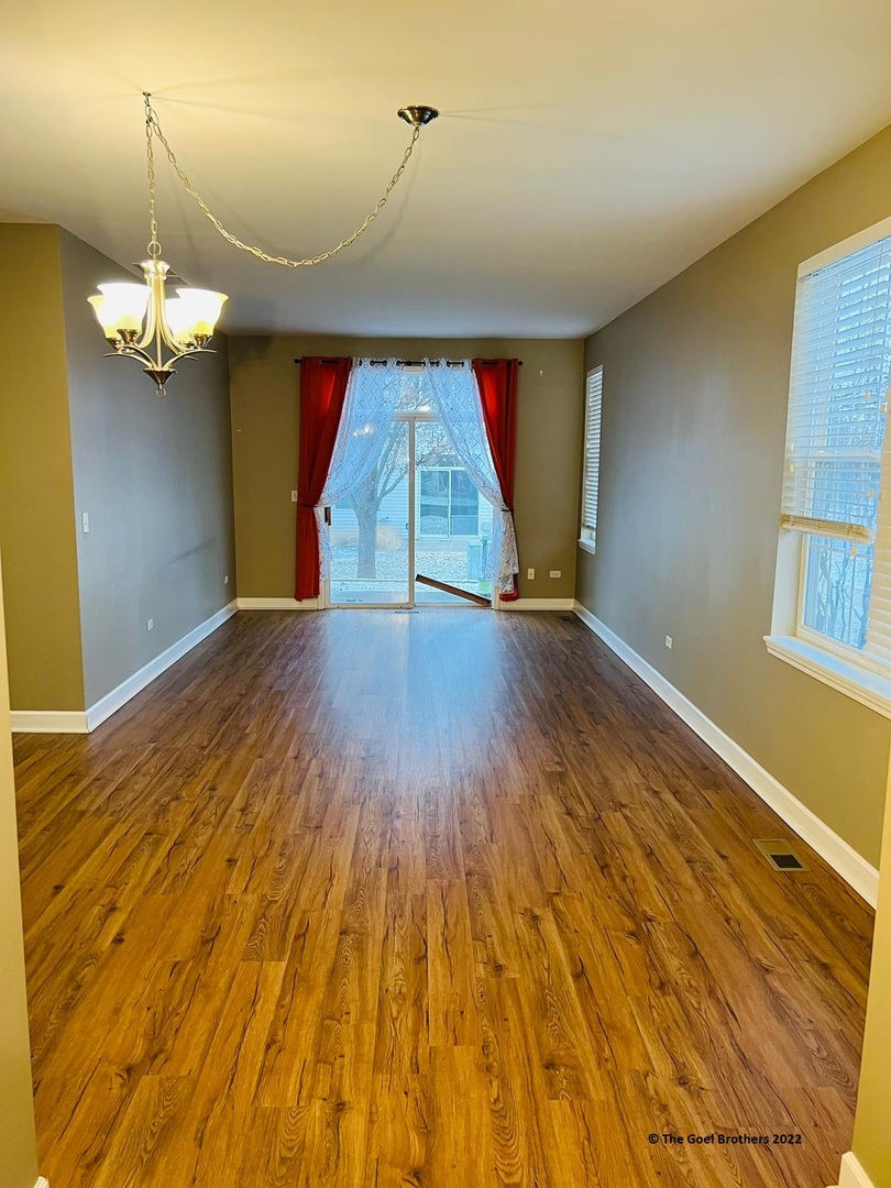 3175 Falling Waters Lane Lindenhurst, IL 60046 - Photo 4 of 19 a view of empty room with wooden floor and fan