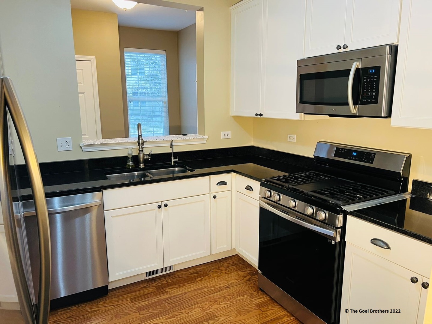 3175 Falling Waters Lane Lindenhurst, IL 60046 - Photo 7 of 19 a kitchen with granite countertop white cabinets and black appliances
