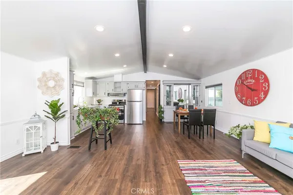 a dining room with furniture and wooden floor