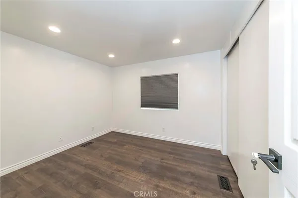 a view of a room with wooden floor