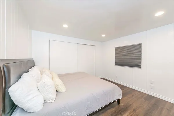 a bedroom with a bed and a white wall