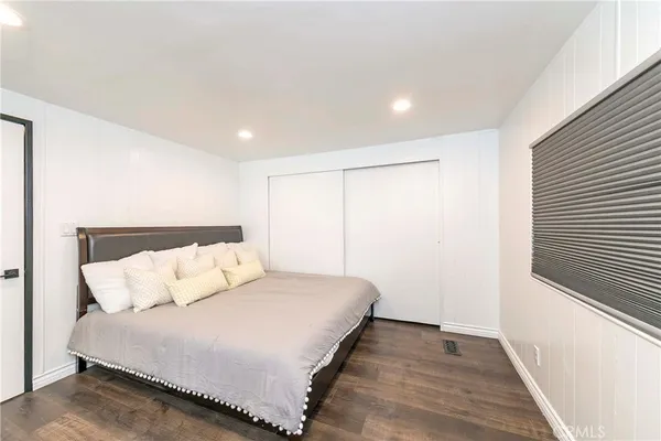 a bedroom with a bed and a walk in closet