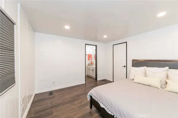 a spacious bedroom with a bed and a closet