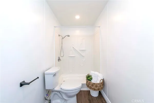 a bathroom with a granite countertop toilet and a shower