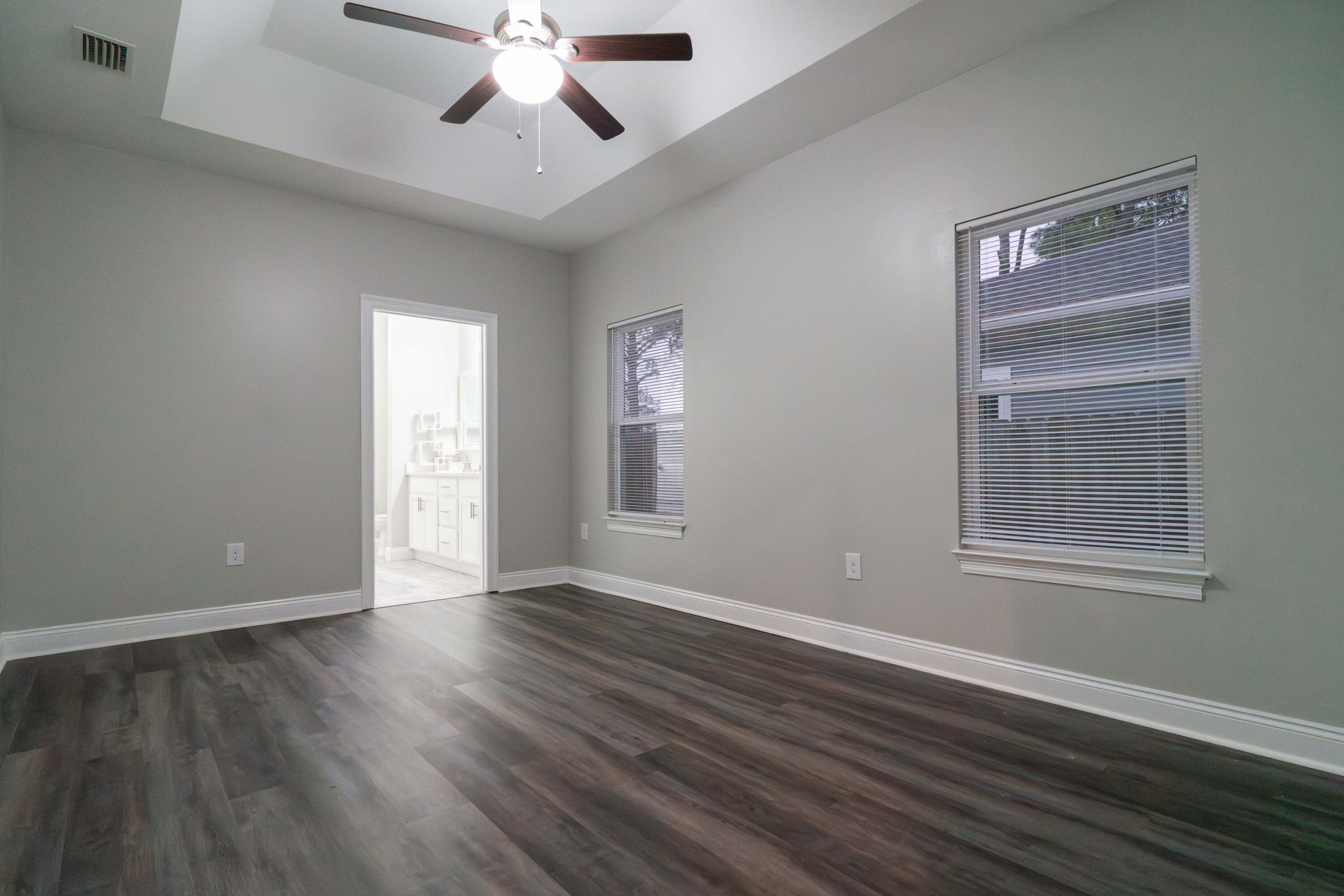 2243 Wind Trace Road North Navarre, FL 32566 - Photo 14 of 34 a view of an empty room with wooden floor and a window
