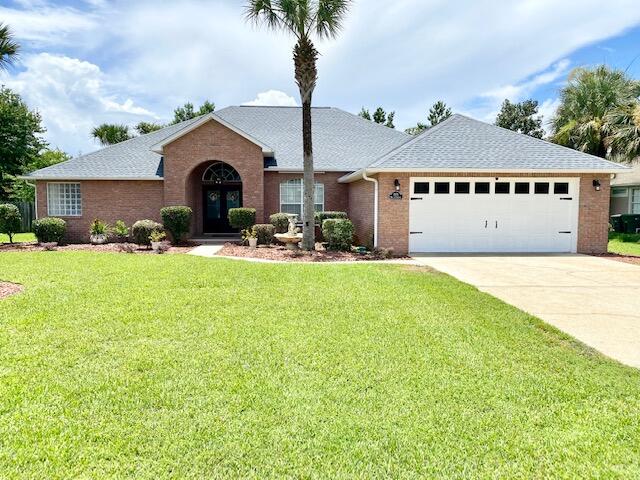 a front view of a house with yard and garage