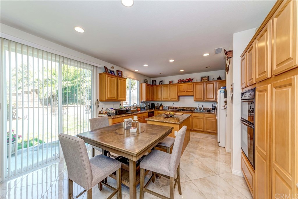 14007 Highlander Road La Mirada, CA 90638 - Photo 19 of 55 a dining room with a table and chairs