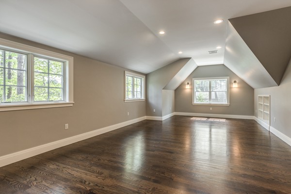 2 Winding Road Lexington, MA 02421 - Photo 17 of 28 an empty room with wooden floor and windows with curtains view