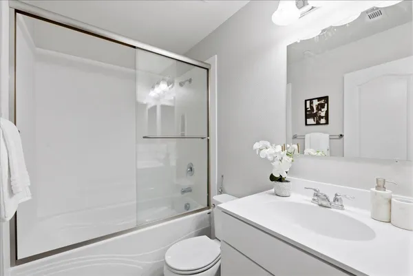 a bedroom with a bed and a potted plant