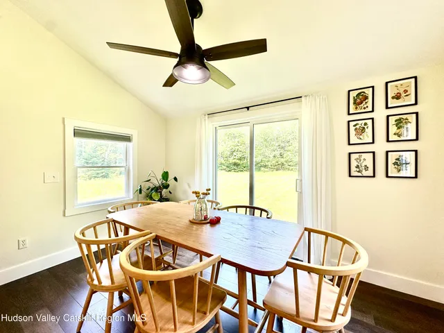 a view of a dining room with furniture window and wooden floor