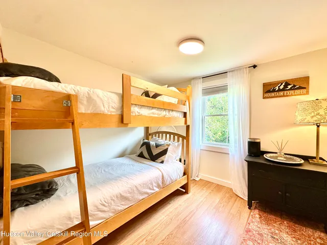 a bedroom with a bed and a night stand