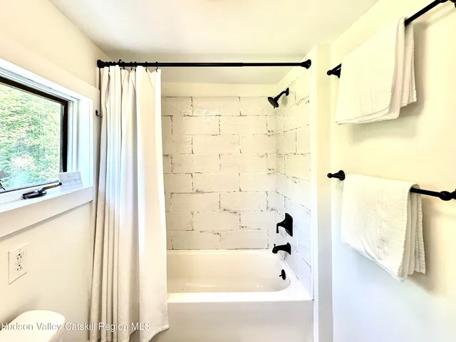 a bathroom with a shower and a bathtub