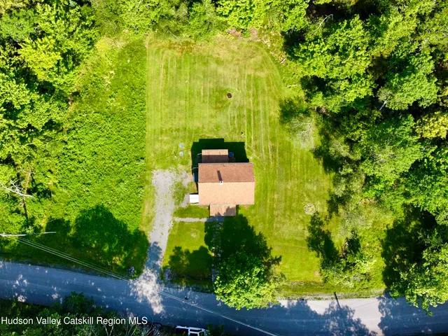 an aerial view of a house with a yard