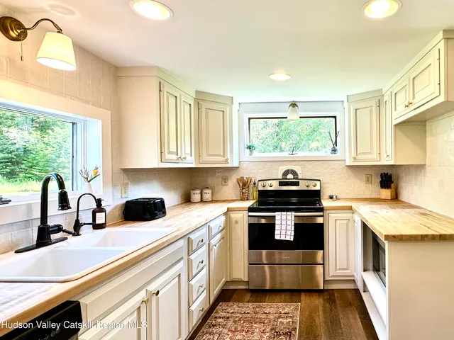 a kitchen with a sink stove and cabinets