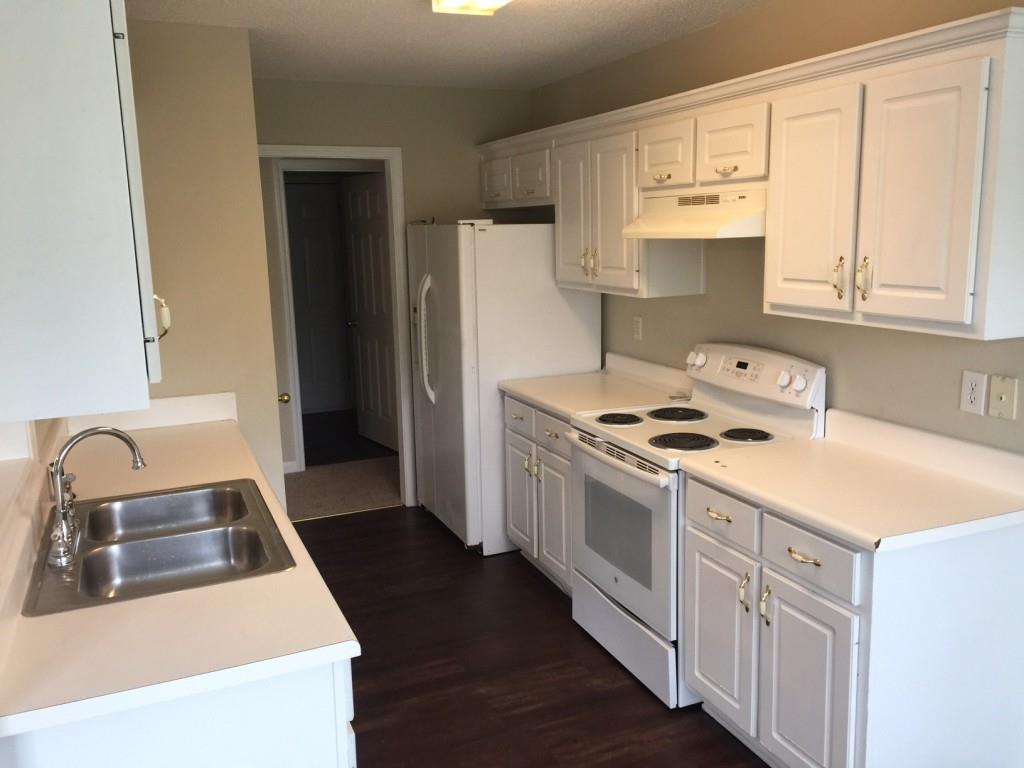 1140 Katie Lynne Lane Dacula, GA 30019 - Photo 2 of 6 a kitchen with stainless steel appliances granite countertop a sink stove and refrigerator