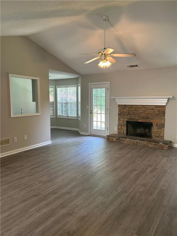1140 Katie Lynne Lane Dacula, GA 30019 - Photo 3 of 6 an empty room with wooden floor fireplace and windows