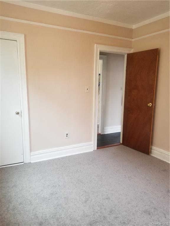 a view of an empty room and closet area