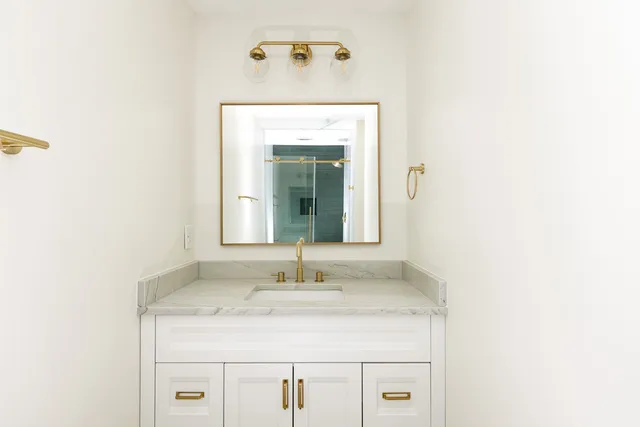 a bathroom with a sink and a mirror