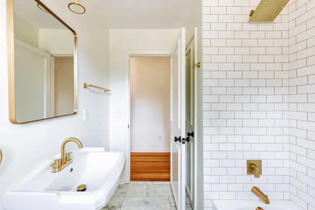 a bathroom with a sink a mirror and shower